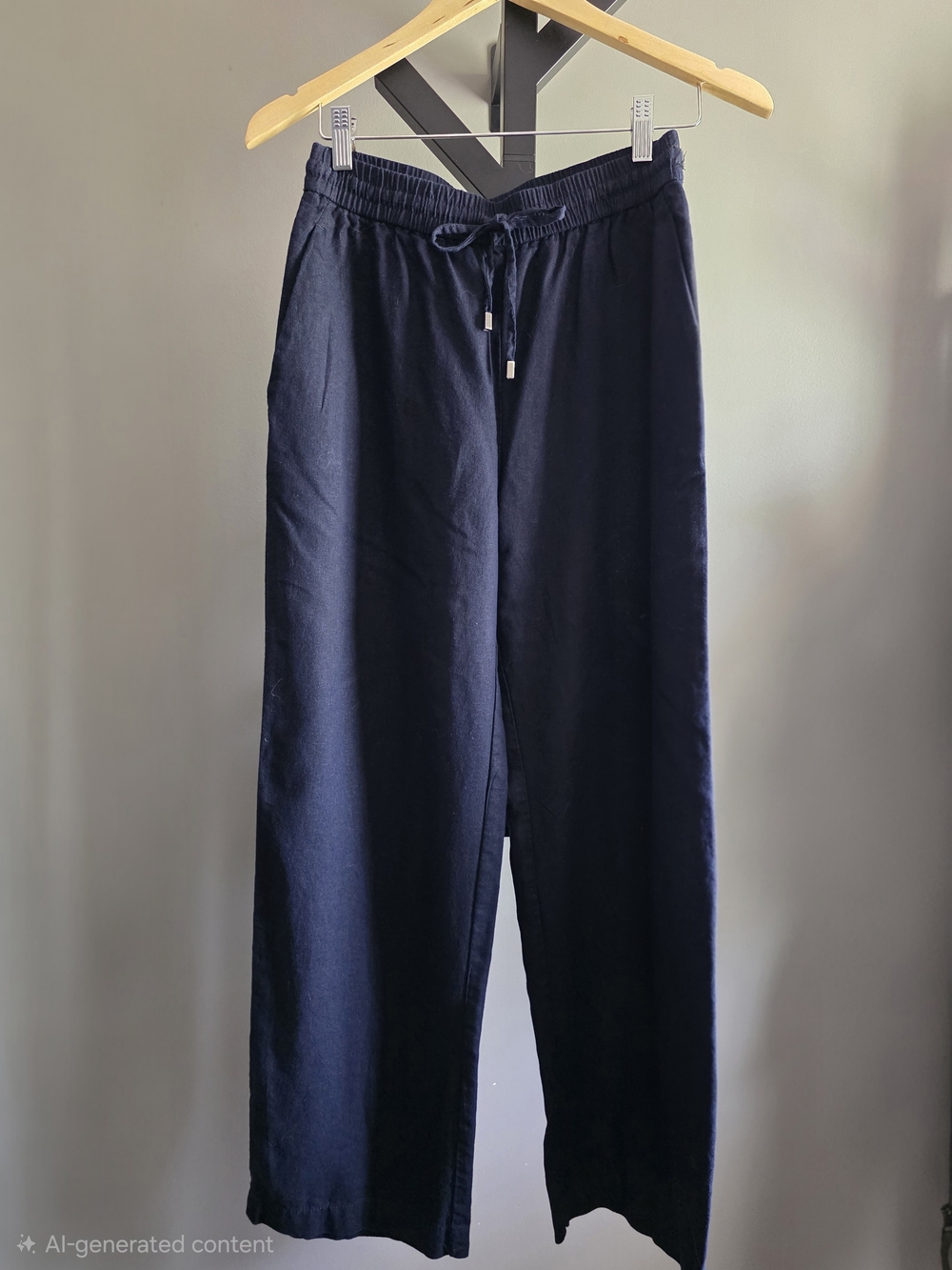 A pair of linen pants from ZARA, available in black and blue.